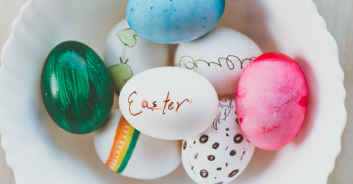 Difference between chicken and duck eggs? - Top view of assorted multicolored chicken eggs with bright handmade ornament in ceramic bowl for festive religious event at home