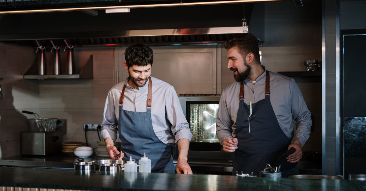 Difference between saucepan, frying pan and skillet - Man in Black Vest and White Dress Shirt Standing Beside Man in Black Vest