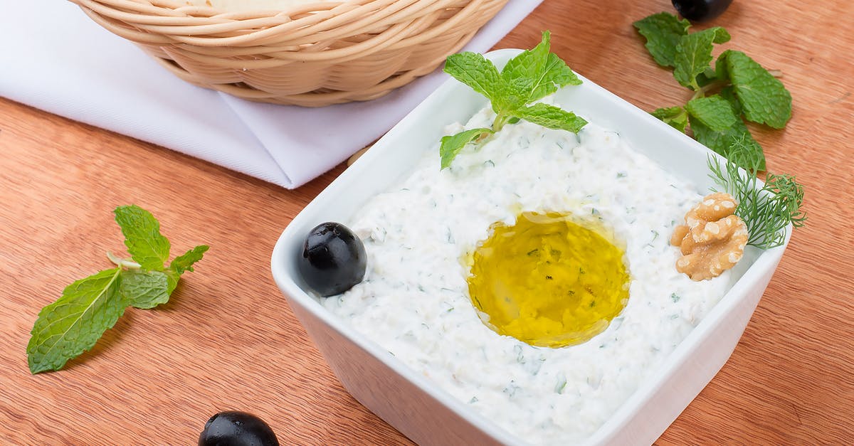 Difference between tzatziki and Indian mint dip (mint chutney?) - White Ceramic Bowl With Yellow Cream on Brown Wooden Table