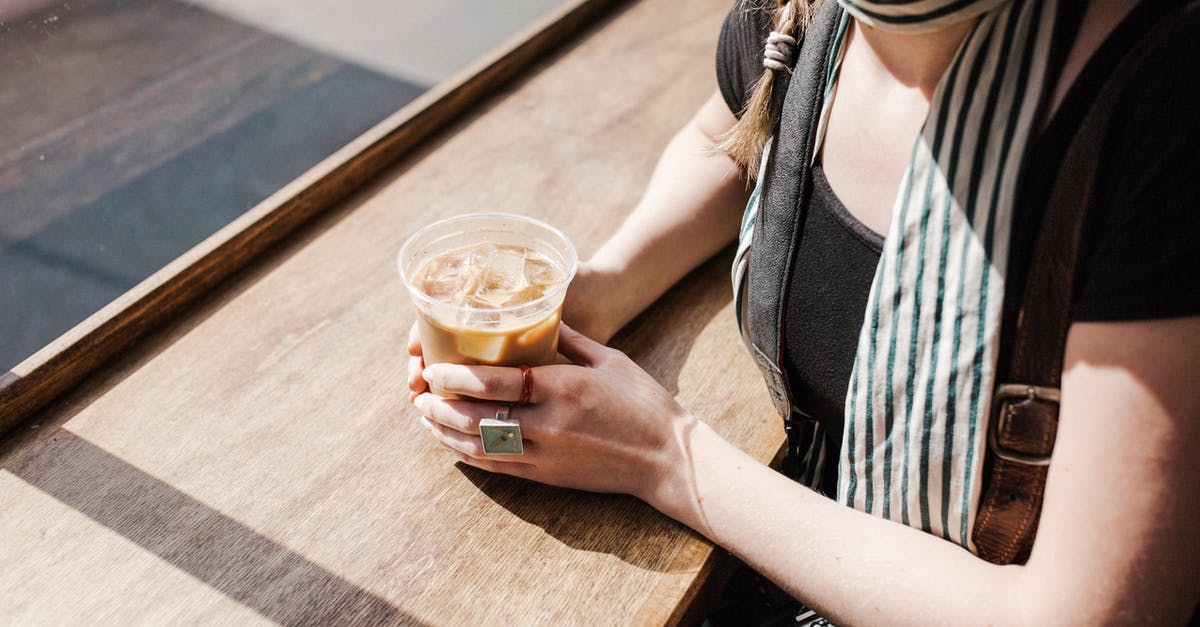 Difference in caffeine levels between light and bold coffee? - Person Holding Iced Coffee