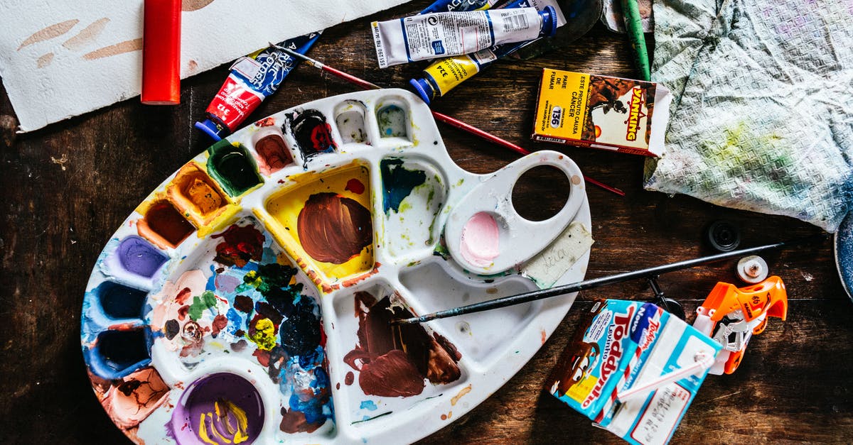 Difference in cookie texture if we use melted vs softened butter - Top view of various art supplies including paintbrushes with colorful tubes of paint and palette placed on wooden table