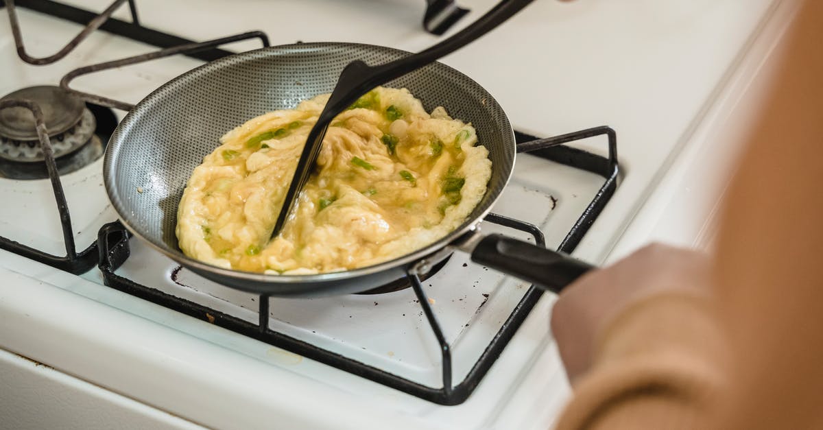 Difference in technique for cooking with non-stick and standard pans? - Person Cooking on Black Frying Pan