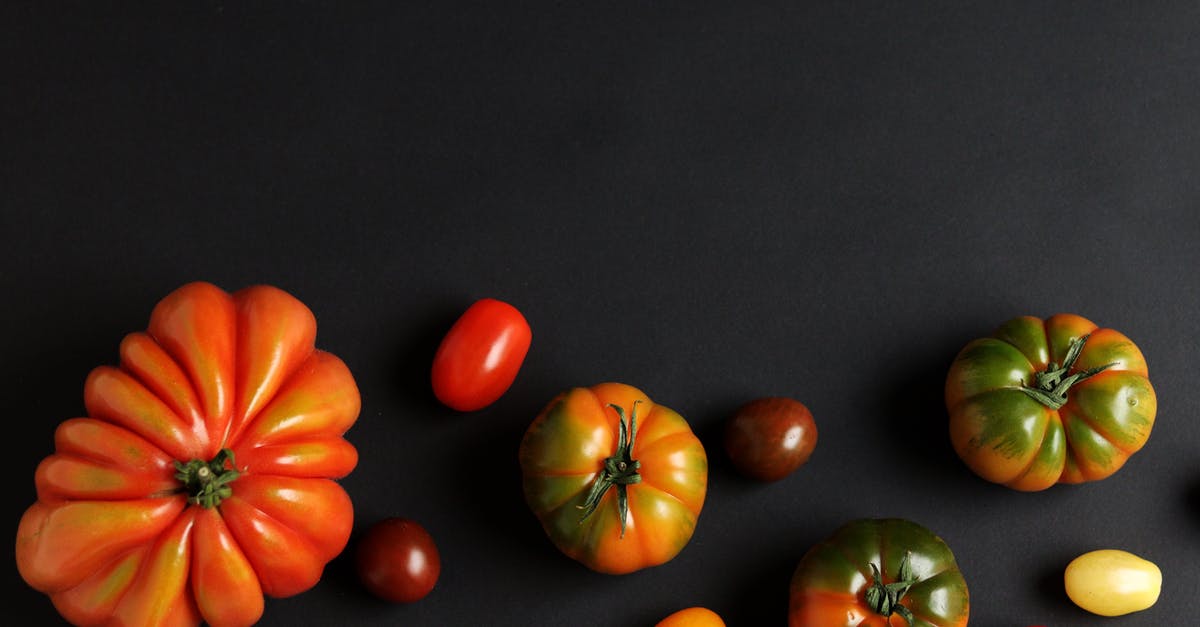 Differences between canned and fresh tomatoes - Different Fresh Tomatoes on Black Background