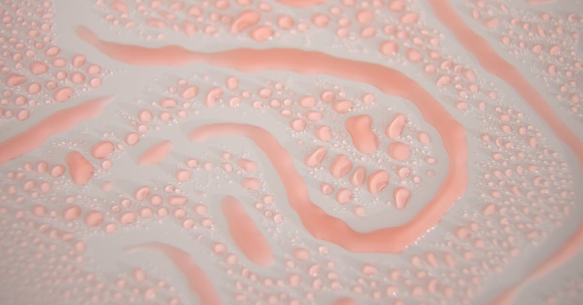 Differences between gel and gelatine - Top view of textured backdrop representing transparent drips and wavy lines with wet surface on white background