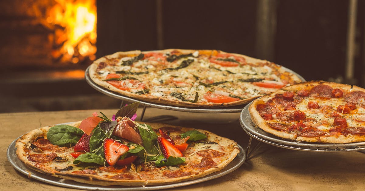 Differences between the oven stone and the pizza oven? - Shallow Focus Photography of Several Pizzas