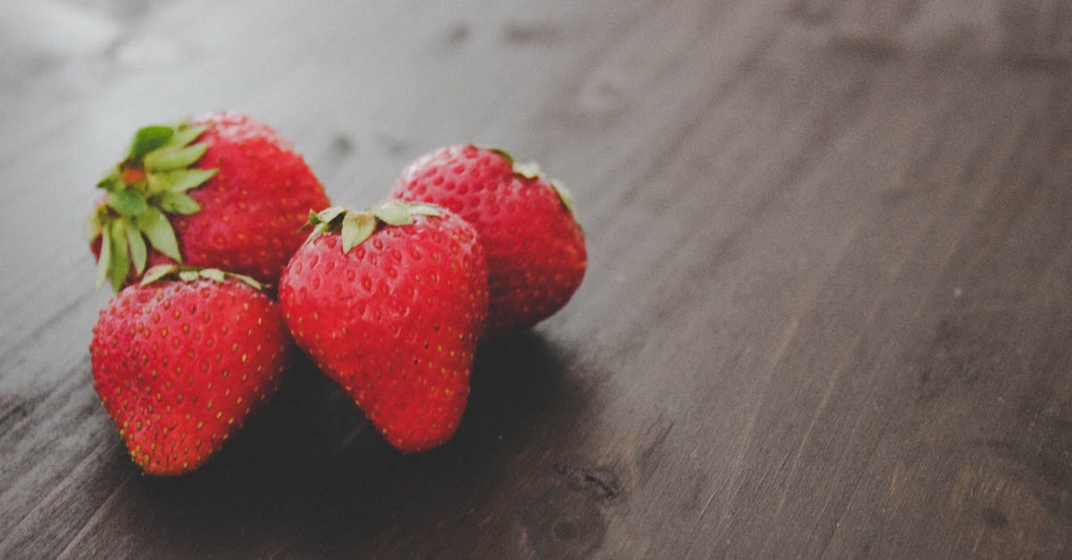 differences in caper berry seeds - Ripe strawberries heap on wooden table