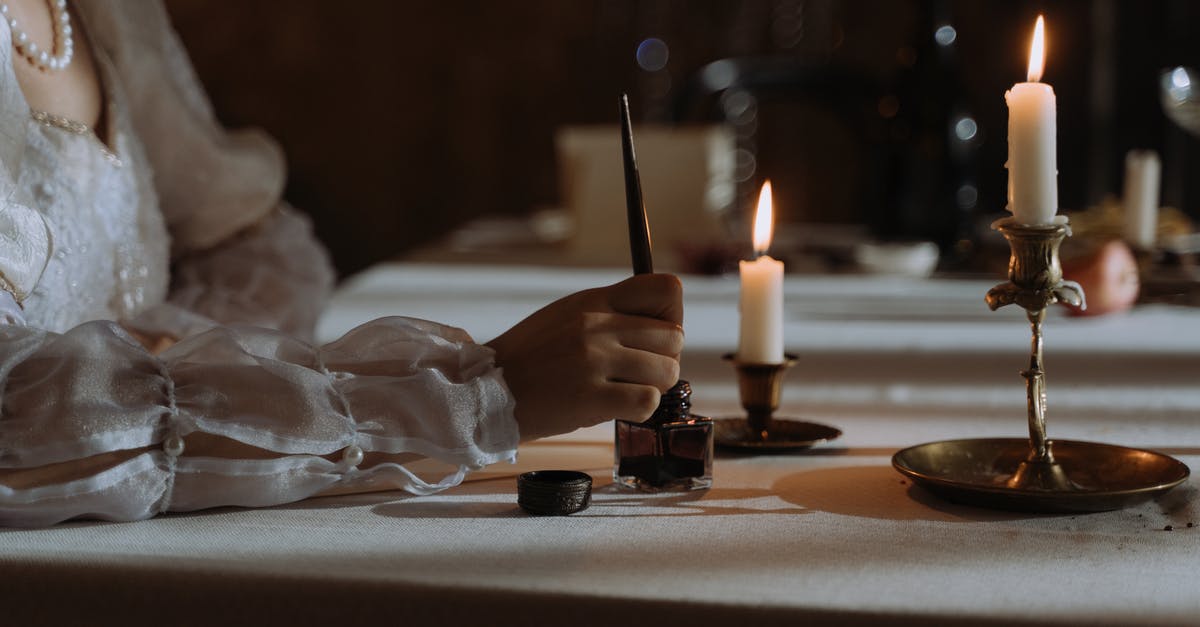 Dipping Cakepops in Callebaut Callets - Person dipping Quill Pen in an Ink