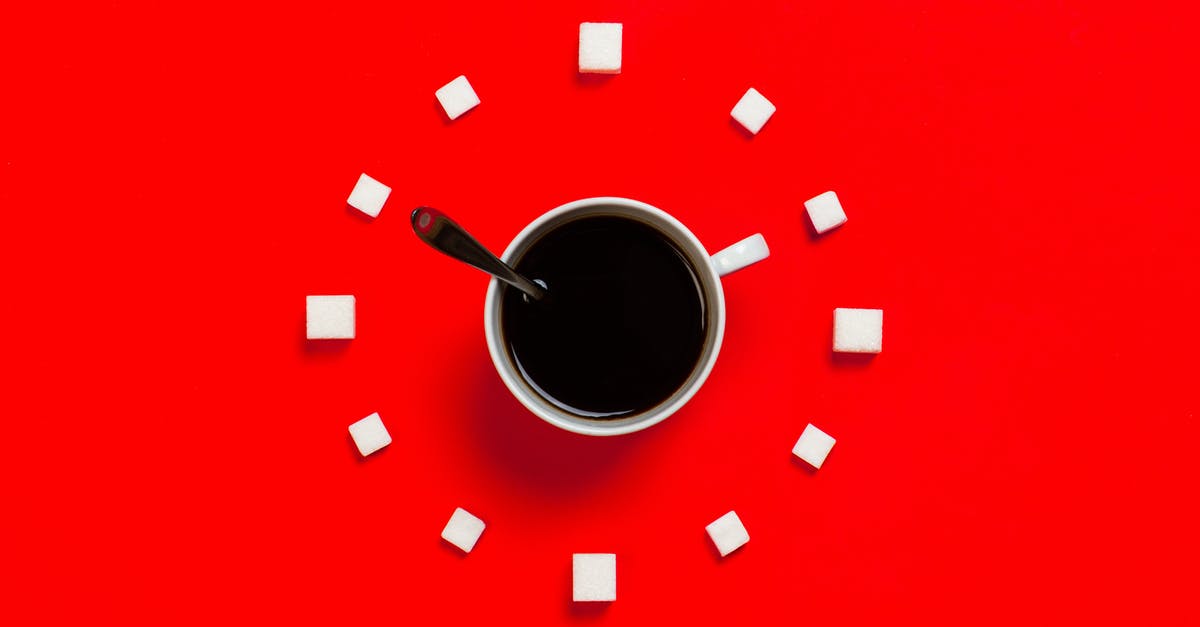 Dissolving sugar in a beverage - White Mug on Red Background