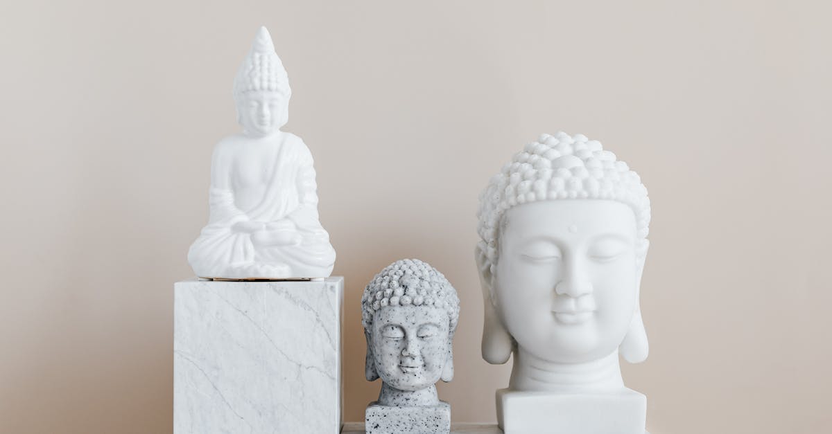 Distinguishing the size of tablecloths when folded? [closed] - Collection of Asian busts and statue of Buddha made of white and gray stone with smooth surface on marble pedestal