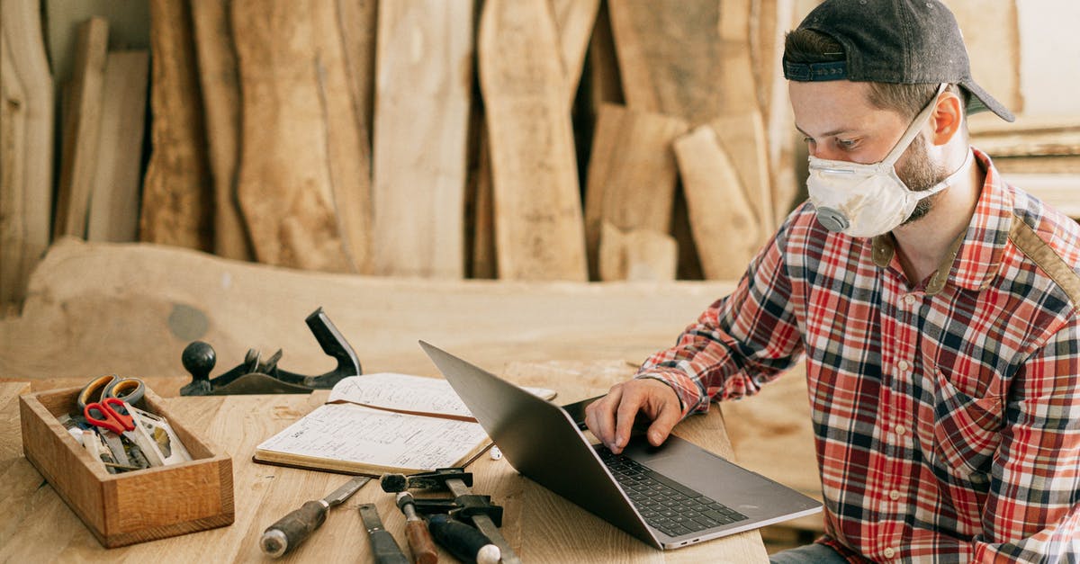 DIY Finishing Salt (Maldon, Fleur de Sel) - Man Using a Laptop at a Wood Workshop