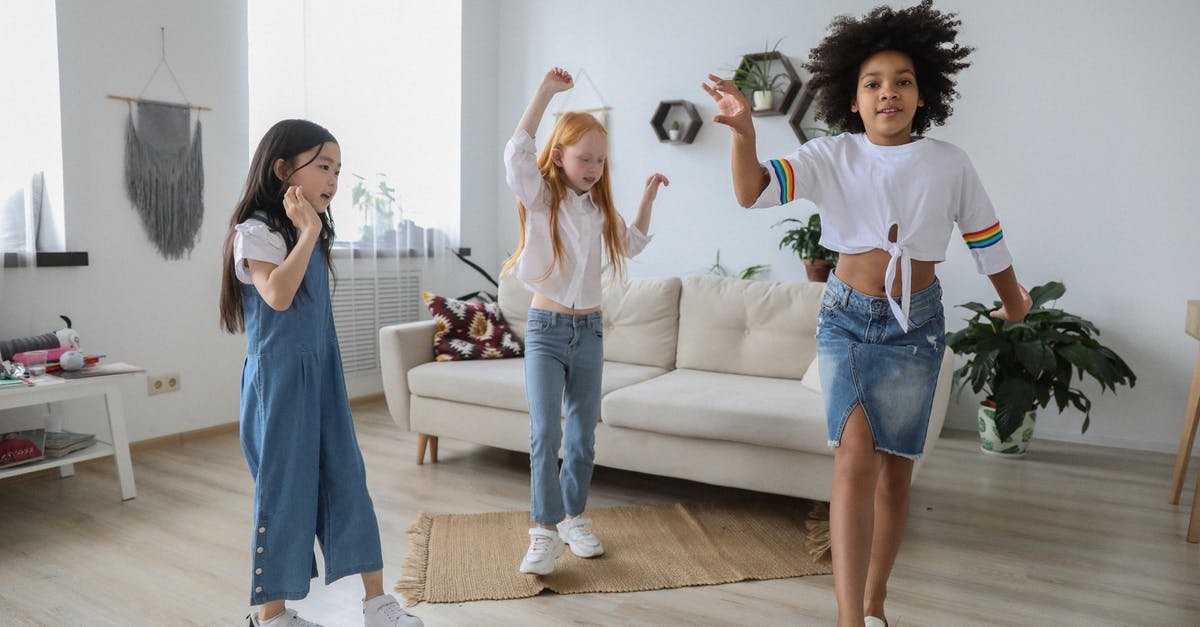 Do all yogurts have live active cultures? - Content multiracial children dancing with raised arms on floor near sofa in living room