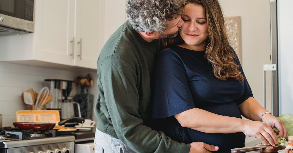 Do burgers cook better when close or far apart? - Romantic couple preparing food in kitchen