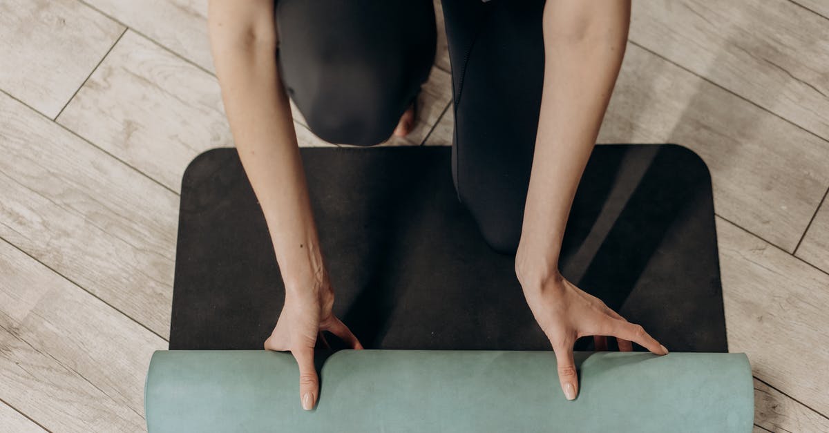 Do Dumplings Mind Being in the Fridge? - Woman in Black Leggings Unrolling A Yoga Mat