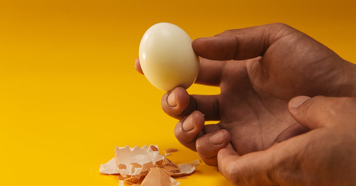 Do eggshells let flavours pass through during boiling? - Person Holding Boiled Egg 