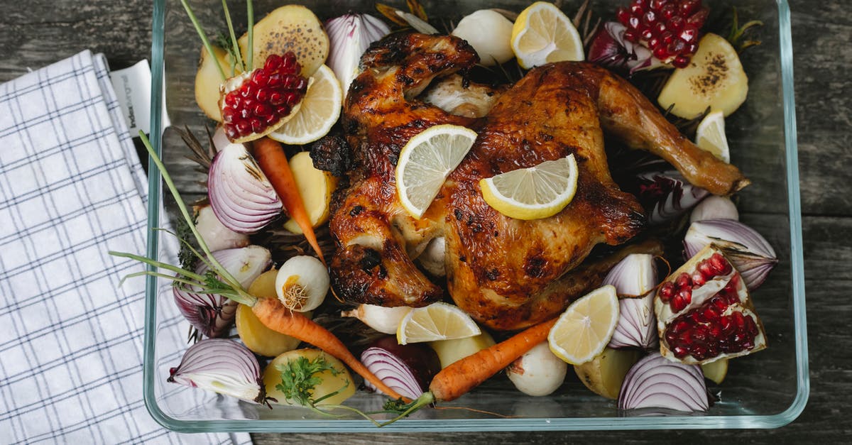 Do I have to peel red potatoes before baking them? - Delicious roasted chicken with assorted vegetables and fruits on table