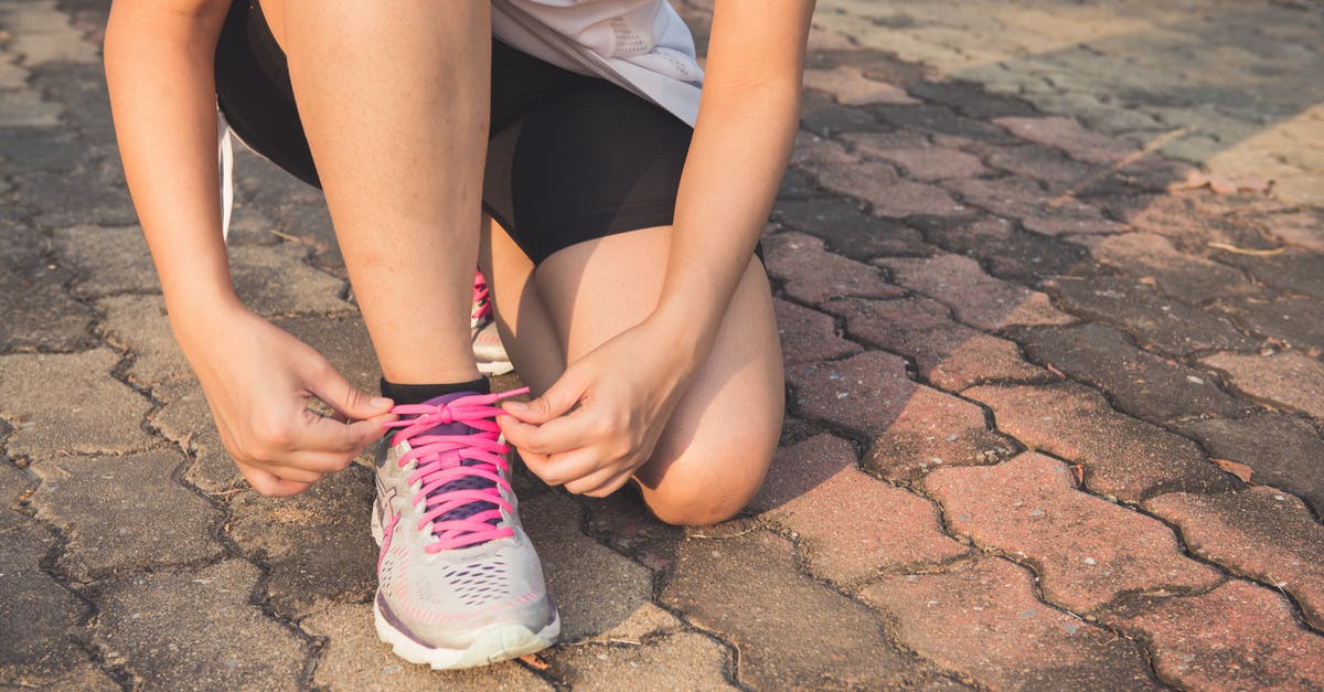 Do I have to tie my turkey legs together? - Woman Lacing Up Her Gray and Pink Nike Low-top Athletic Shoe