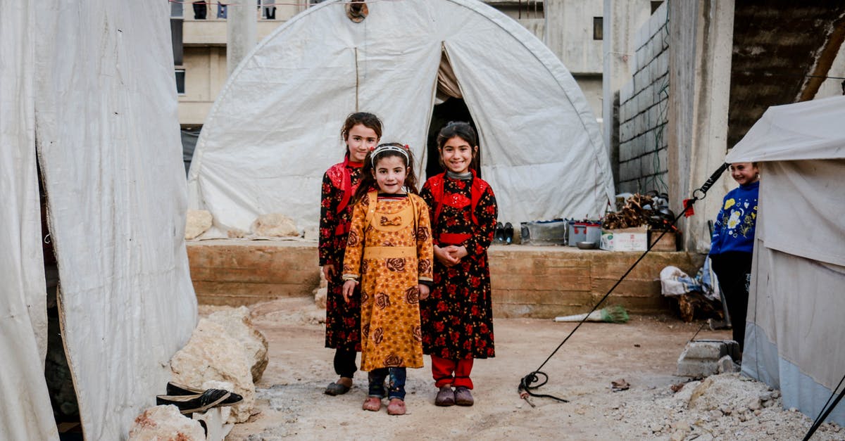 Do I need to baste an injected turkey? - Three Girls in Floral Dresses Smiling and Standing Near White Tent