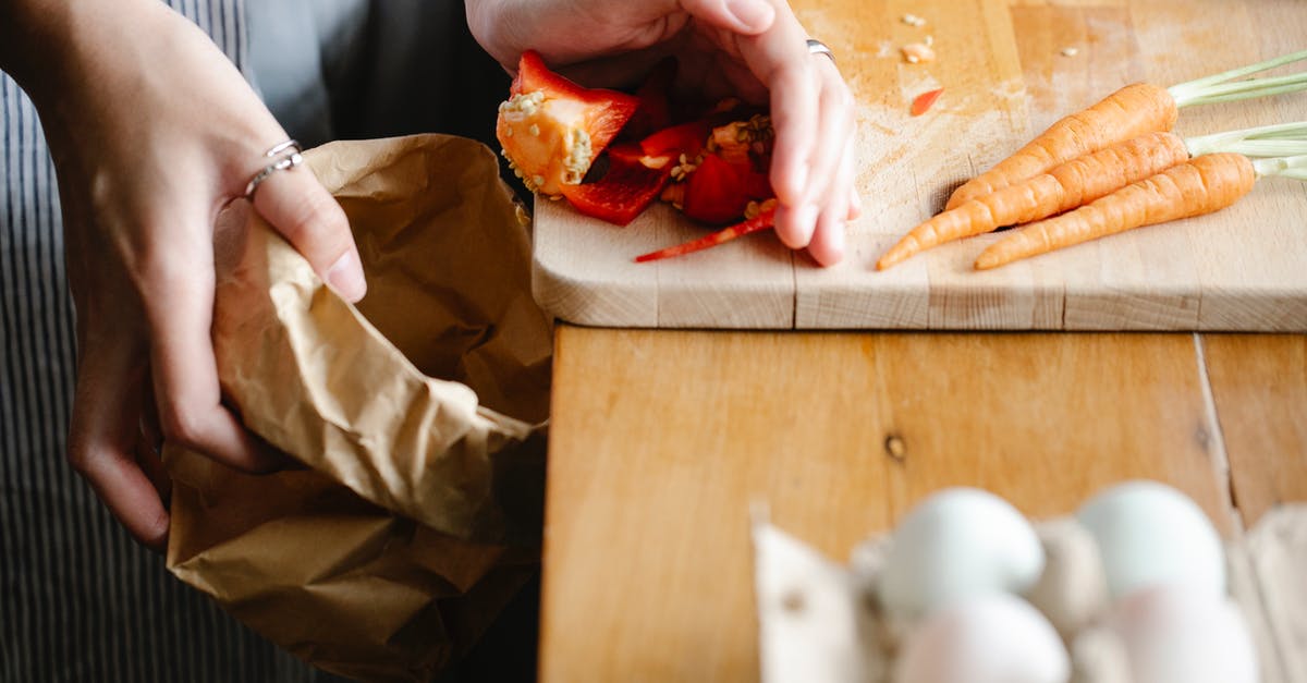 Do I need to boil flax seed egg substitute? - Unrecognizable female putting seeds of red bell pepper from cutting board into carton package while cooking at counter with carrots and eggs