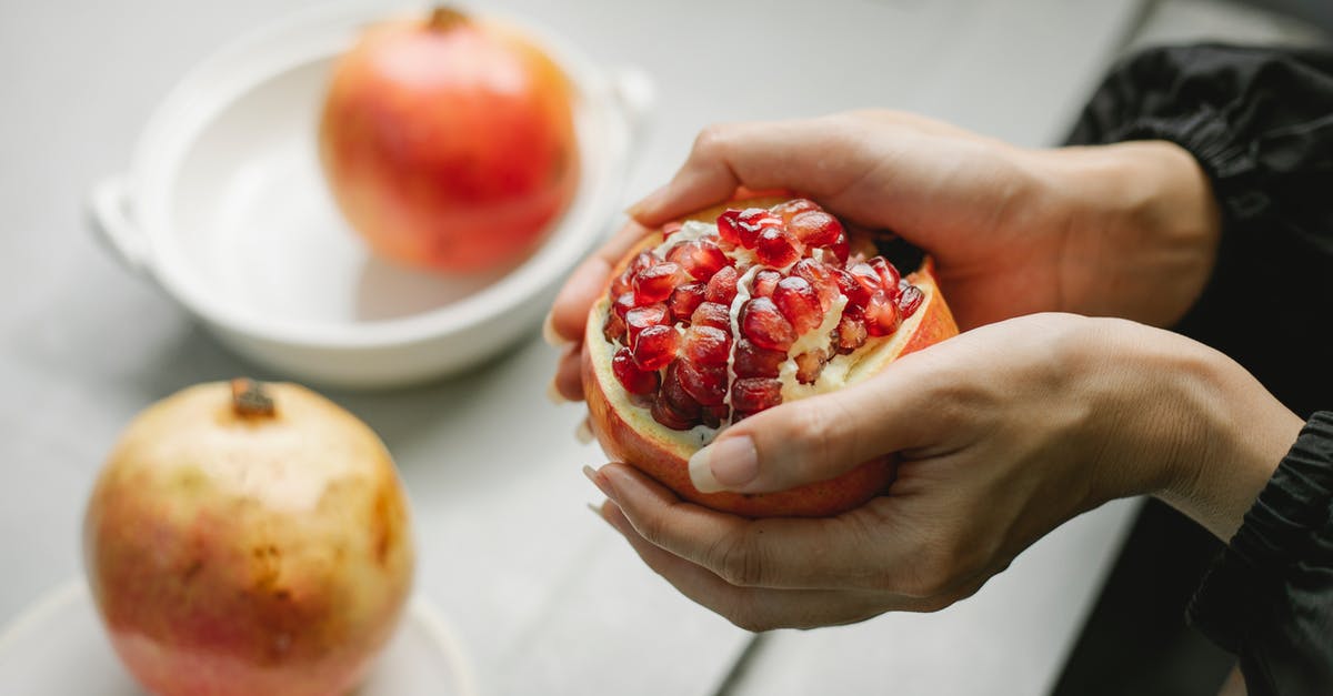 Do I need to peel a red kuri squash? - Crop woman with peeled pomegranate in hands