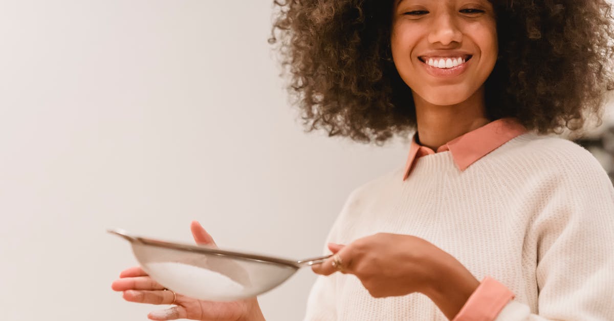 Do I need to sift flour that is labeled sifted? - Cheerful black woman sifting flour