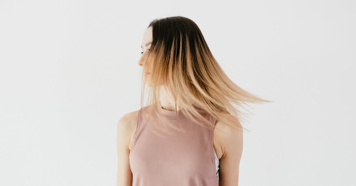 Do I need to use sterilized jars straight away? - Serious unrecognizable young female in casual outfit with long loose hair hiding face standing against white background and looking away