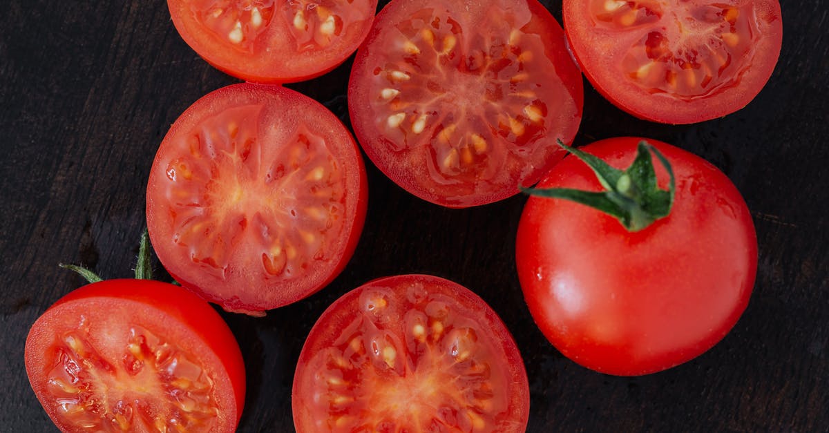 Do I use half as much "double concentrated" tomato paste? - Halves of tomatoes and whole tomato on cutting board