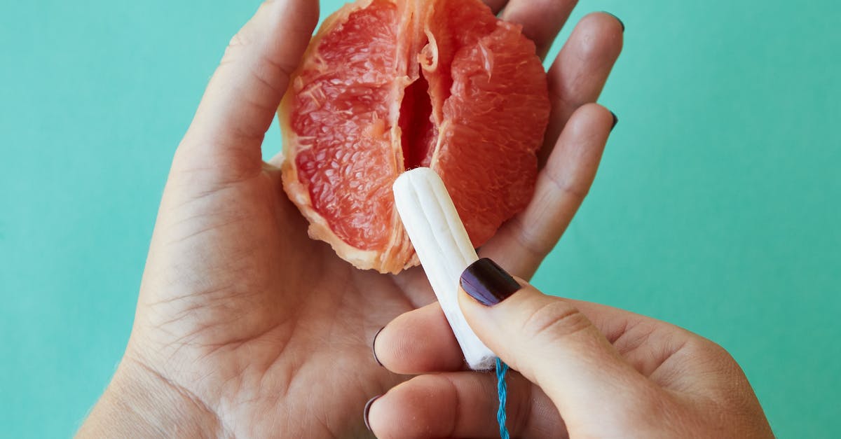 Do I use half as much "double concentrated" tomato paste? - From above of crop anonymous female demonstrating on sliced ripe grapefruit correct use of tampon against blue background