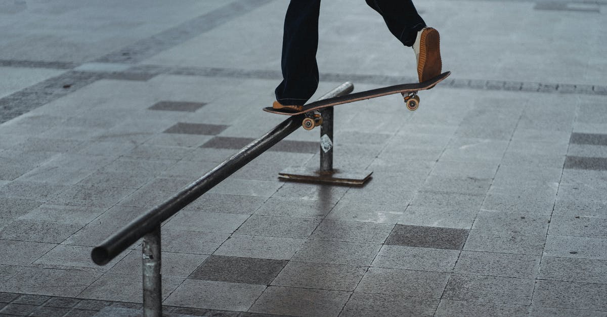 Do induction cookers increase risk of cracking cast iron? - Back view of crop anonymous male in jeans showing trick with skateboard on iron railing placed on concrete tile