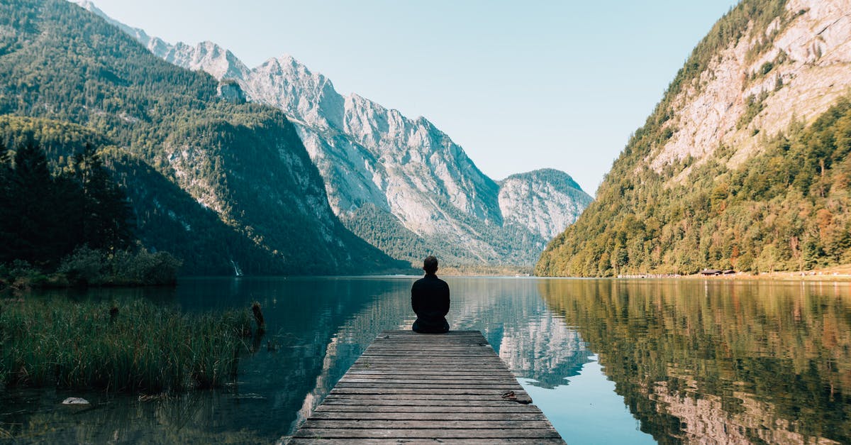 Do quiet induction burners exist? - A Person Sitting on Wooden Planks Across the Lake Scenery