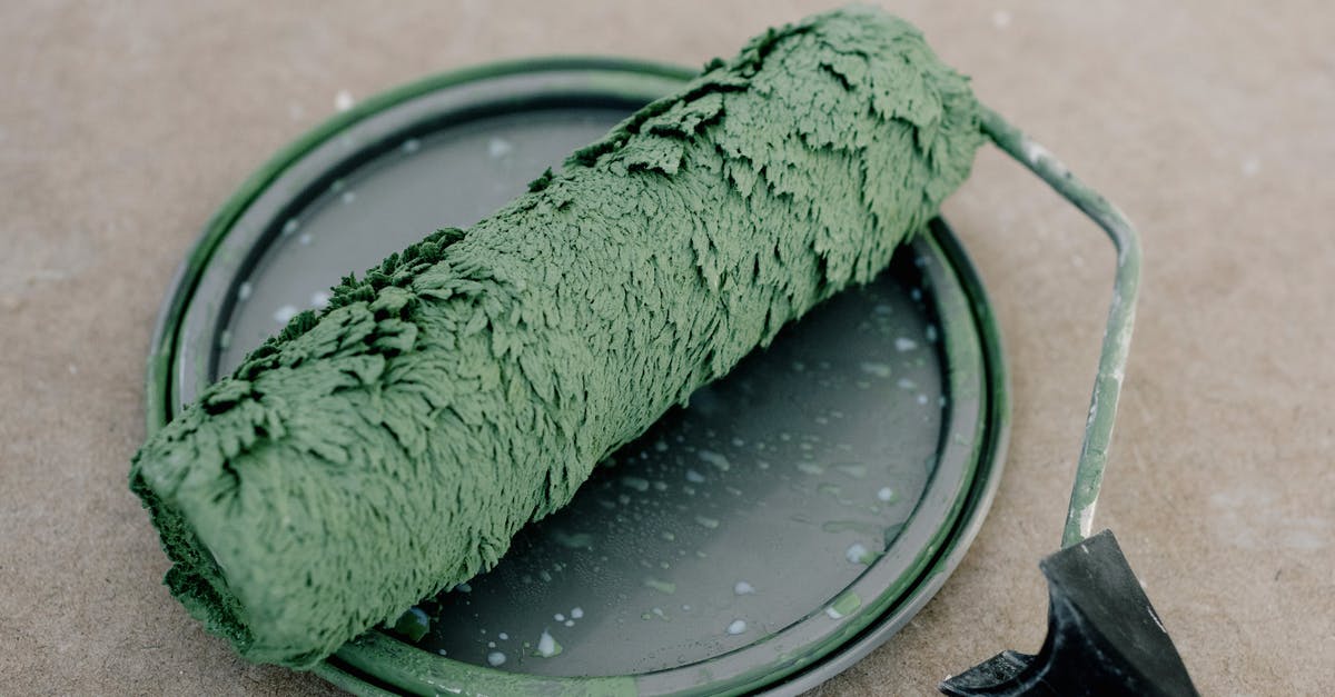 Do slow cookers require liquid to operate? - High angle of wet dirty roller for painting on plastic cap from paint on floor