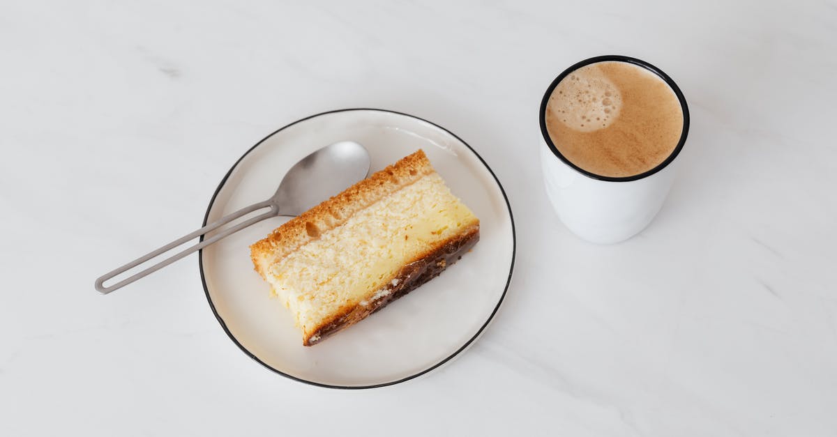 Do these lines in ceramic pie plate mean cracks? - From above of cup of hot coffee near white plate with delicious piece of cake placed on white marble tabletop