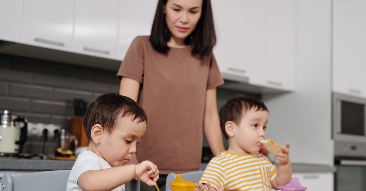 Do tinned foods go off (stale)? - Woman in Brown Shirt Carrying Baby in White and Yellow Stripe Shirt