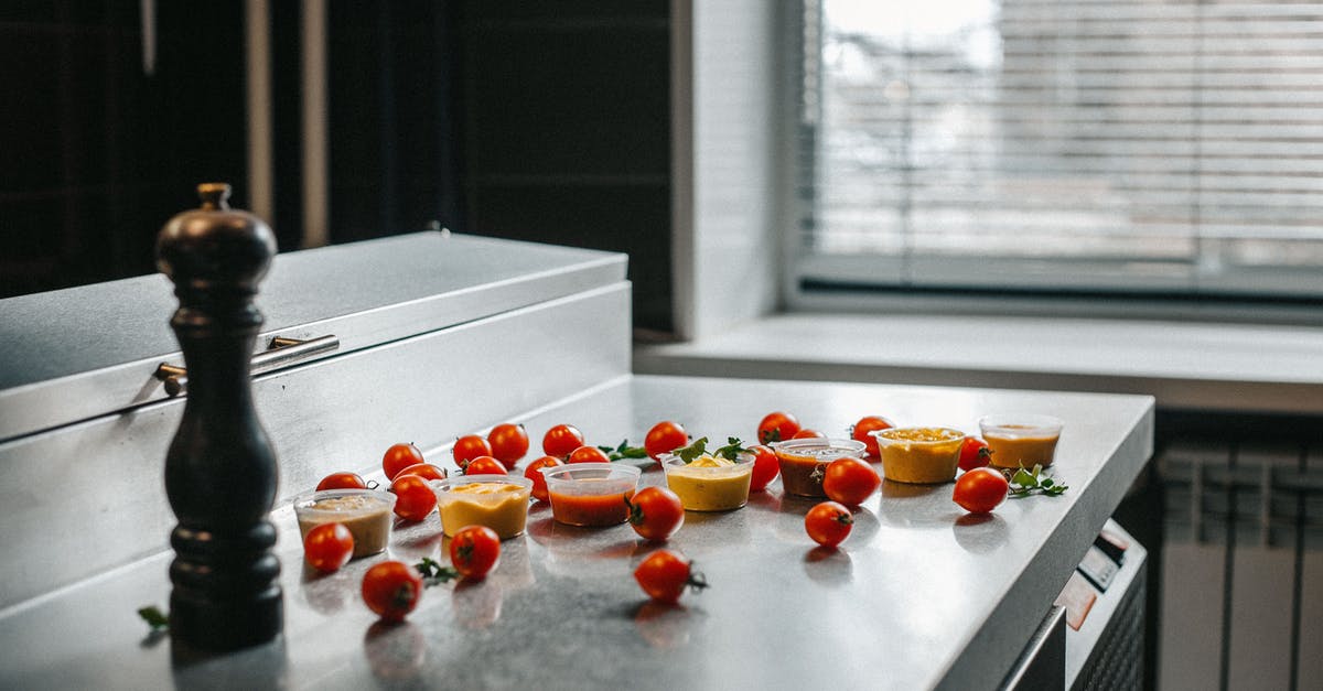 Do tomato-based sauces change/enhance flavour when left in the fridge? - Red Tomatoes and Sauces on a Kitchen Counter