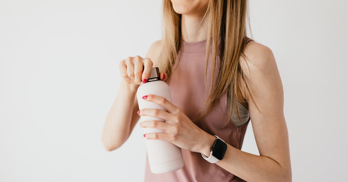 Does a long marinade time matter for chicken, shrimp, etc? - Crop faceless young female in casual outfit wearing smart watch opening cosmetic bottle while standing against white background