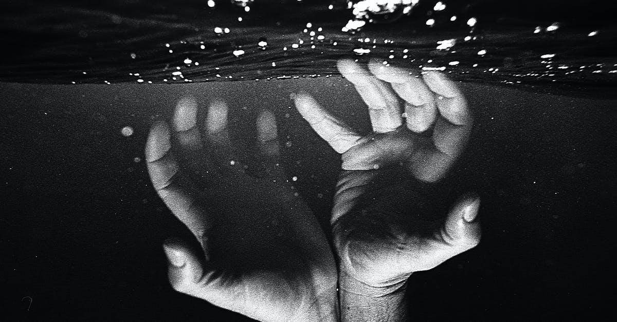 Does adding salt help water boil faster? - Hands of crop faceless man under water