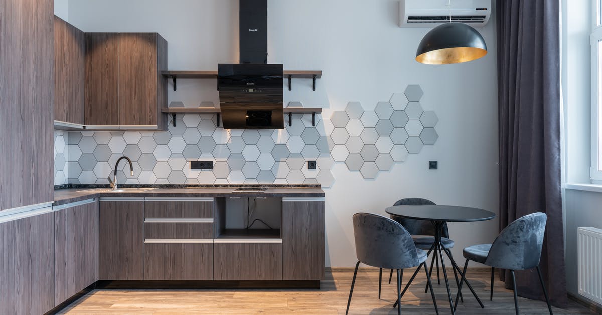 Does an activated carbon filter in a kitchen hood dry the air? - Modern kitchen interior with furniture and lamp at home Does an activated carbon filter in a kitchen hood dry the air? - Modern kitchen interior with furniture and lamp at home