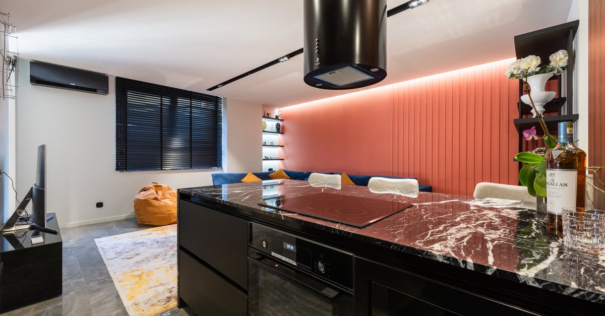 Does an activated carbon filter in a kitchen hood dry the air? - Modern kitchen interior with hob under hood at home Does an activated carbon filter in a kitchen hood dry the air? - Modern kitchen interior with hob under hood at home