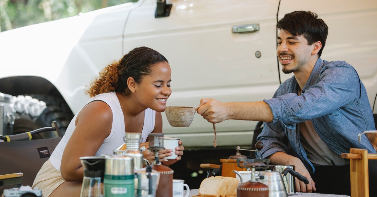 Does an Instant Pot actually save time? - Happy young ethnic female smelling aromatic tea while having breakfast with boyfriend during picnic in nature on sunny day