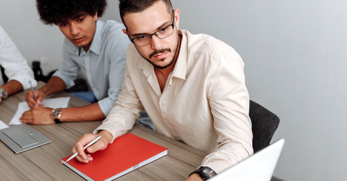 Does anybody know what company made this spatula? - Man Wearing Beige Dress Shirt Looking at a Laptop