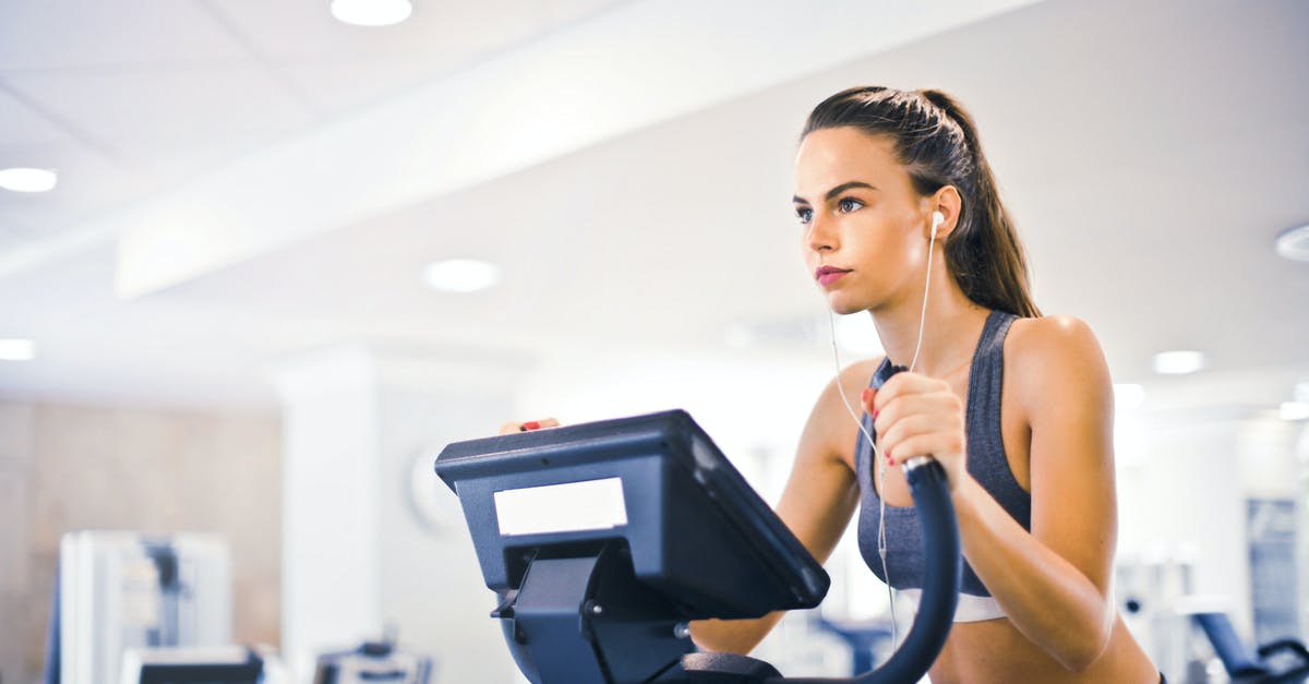 Does blanching cause loss of mass/weight in the vegetable? - Serious fit woman in earphones and activewear listening to music and running on treadmill in light contemporary sports center
