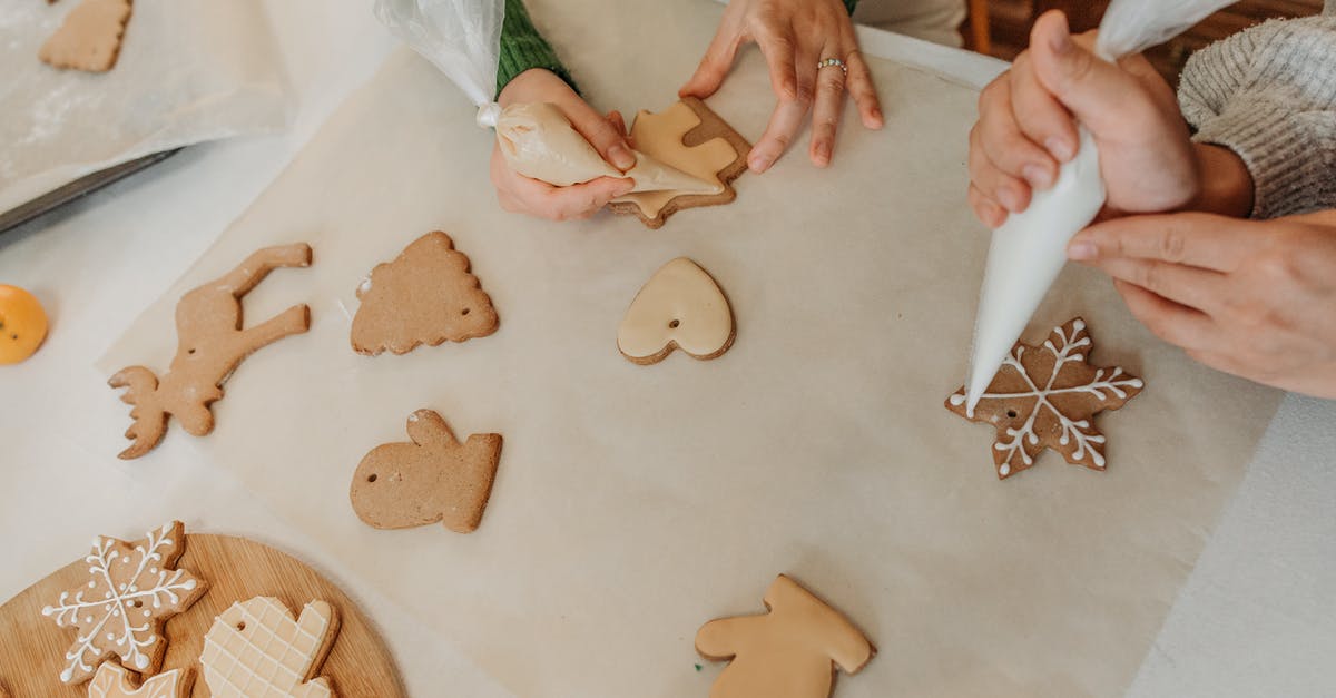 Does cooking or baking with honey make it toxic? - Two Girls Decorating Christmas Cookies With Icing