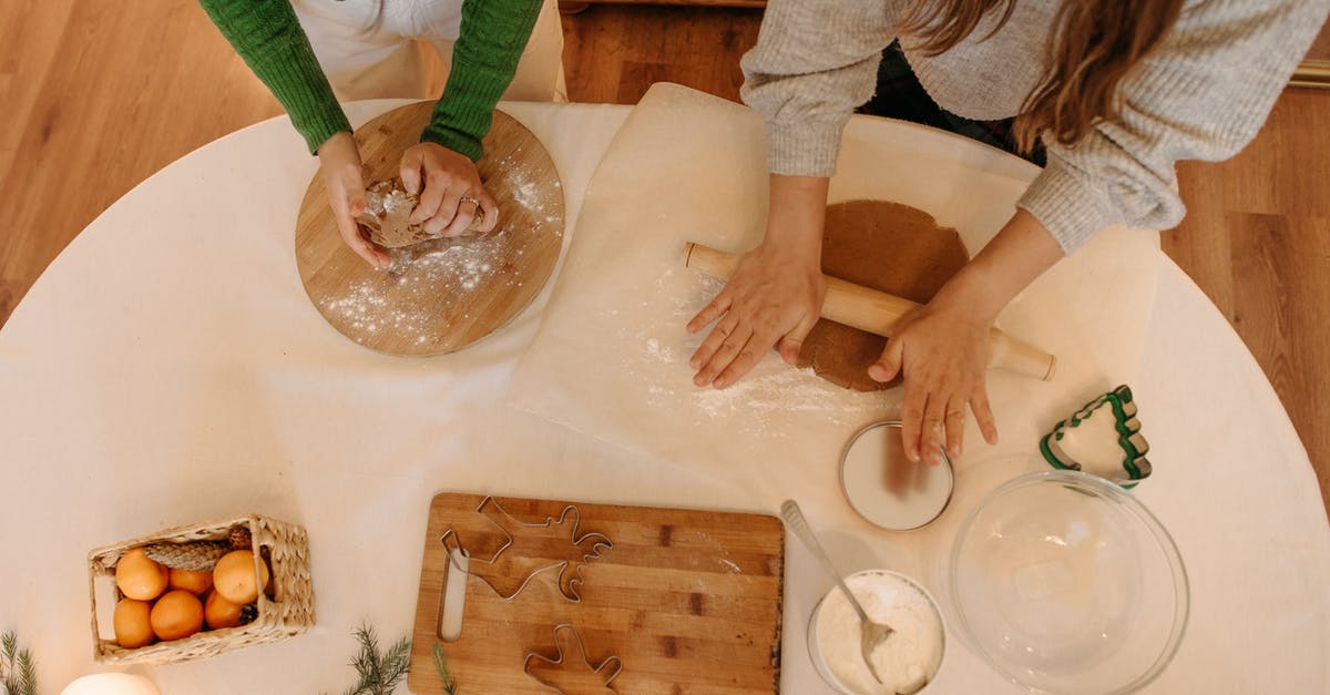 Does cooking or baking with honey make it toxic? - Person in Green Long Sleeve Shirt Slicing Bread