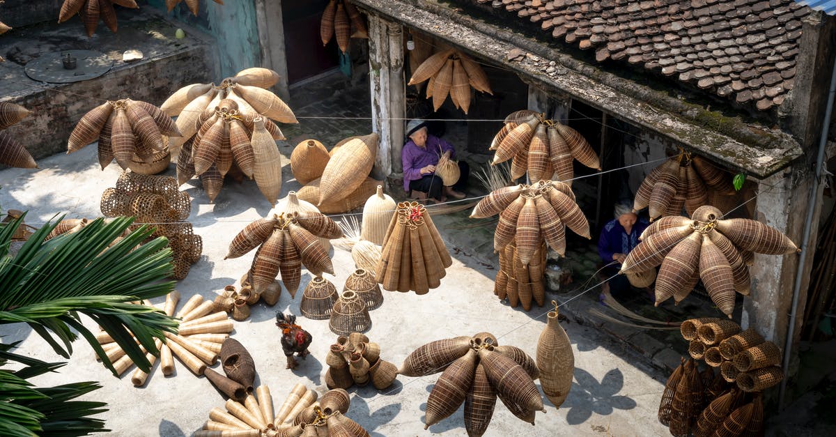 Does ghee make a good substitution for lard? - From above of people sitting and making bamboo fish traps while working on local bazaar in Vietnam in daylight