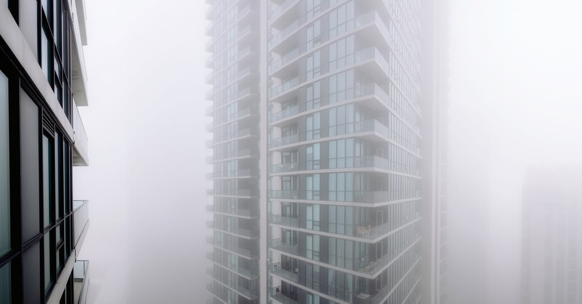 Does invisible mould exist? - Contemporary residential building with balconies covered with thick fog located on street of modern city with houses in overcast weather