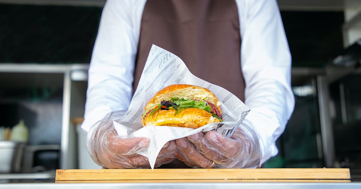 Does it matter what order ingredients are sauteed in? - Cook standing in food truck and giving burger