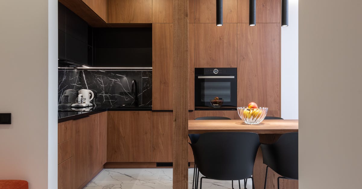 Does ketchup belong in the fridge, or the cupboard? - Wooden furniture and table in contemporary kitchen with dining zone