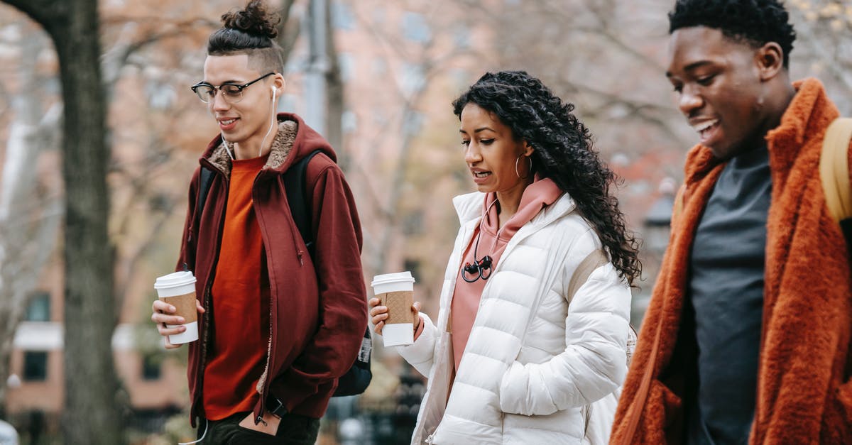 Does Kombucha Tea spoil if left outside of refrigeration? - Group of multiethnic students walking on street with coffee cups