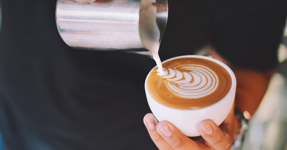 Does milk matter to achieve the perfect latte? - Person Holding White Cup