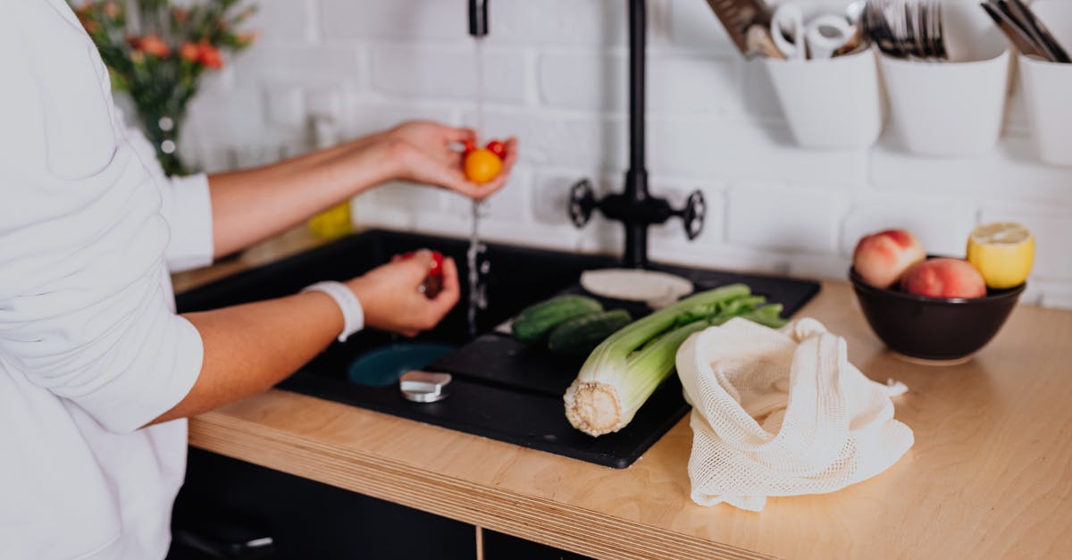 Does pasta boiled in tap water absorb chemicals? - Woman Washing Fresh Ingredients under Tap Water in Kitchen