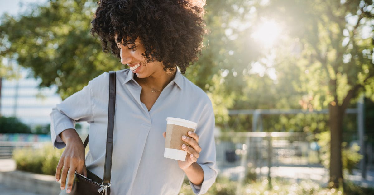 Does putting salt in coffee really remove bitterness? - Photograph of a Woman Putting Something in Her Purse